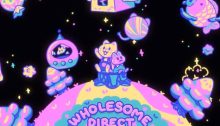 Wholesome Games Direct 2022 logo shows a yellow cat and pink bunny on a tree stump on a three dimensional planet surrounded by trees, a space ship house, a floating fish and more all in colors of pink, yellow, green and blue.